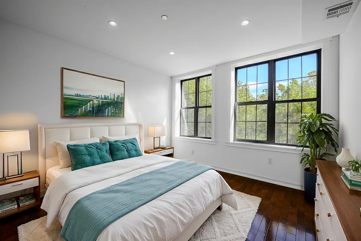 877 Greene Avenue, Unit 2 Brooklyn, NY 11221 - Photo 3 of 13 a bedroom with a large bed and a large window