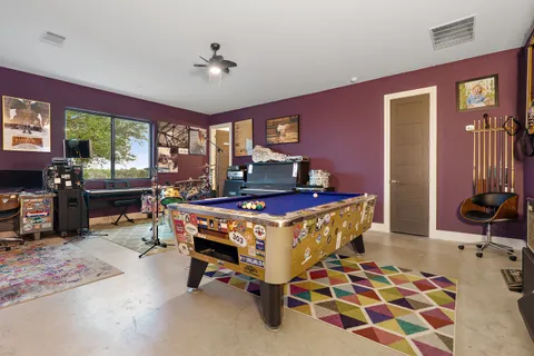 a view of a house with backyard and a tree