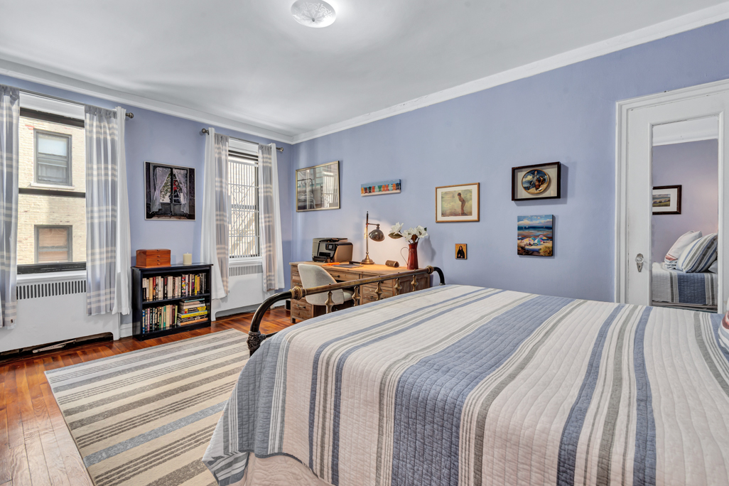 350 Cabrini Boulevard, Unit 6N Manhattan, NY 10040 - Photo 6 of 9 a bedroom with a large bed and a tv