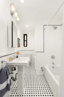 a bathroom with a sink a mirror and a bathtub