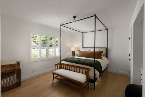 a bedroom with a bed and a window