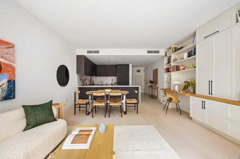 a living room with furniture a rug and a table