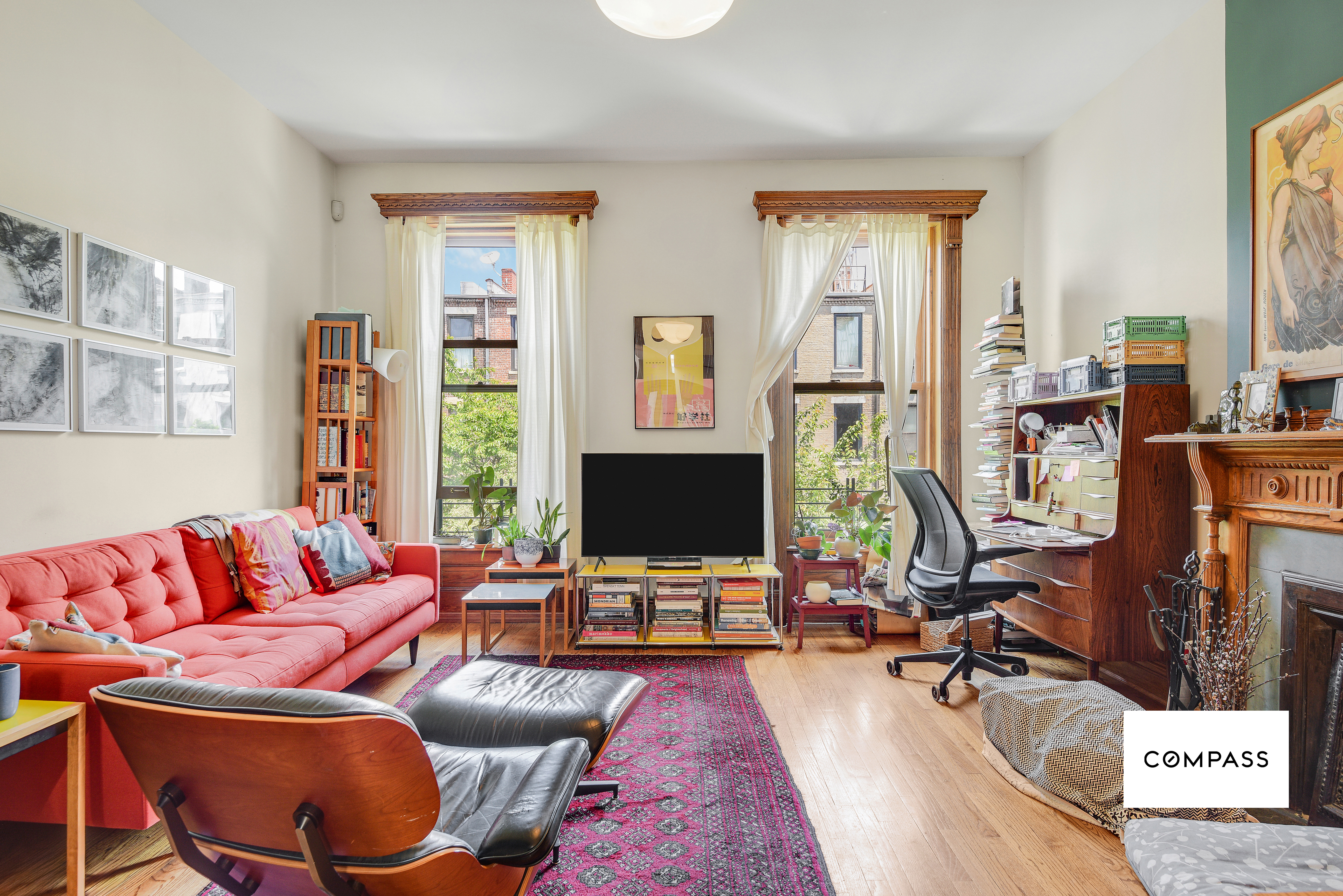 347 West 121st Street Manhattan, NY 10027 - Photo 5 of 10 a living room with furniture a flat screen tv and a window