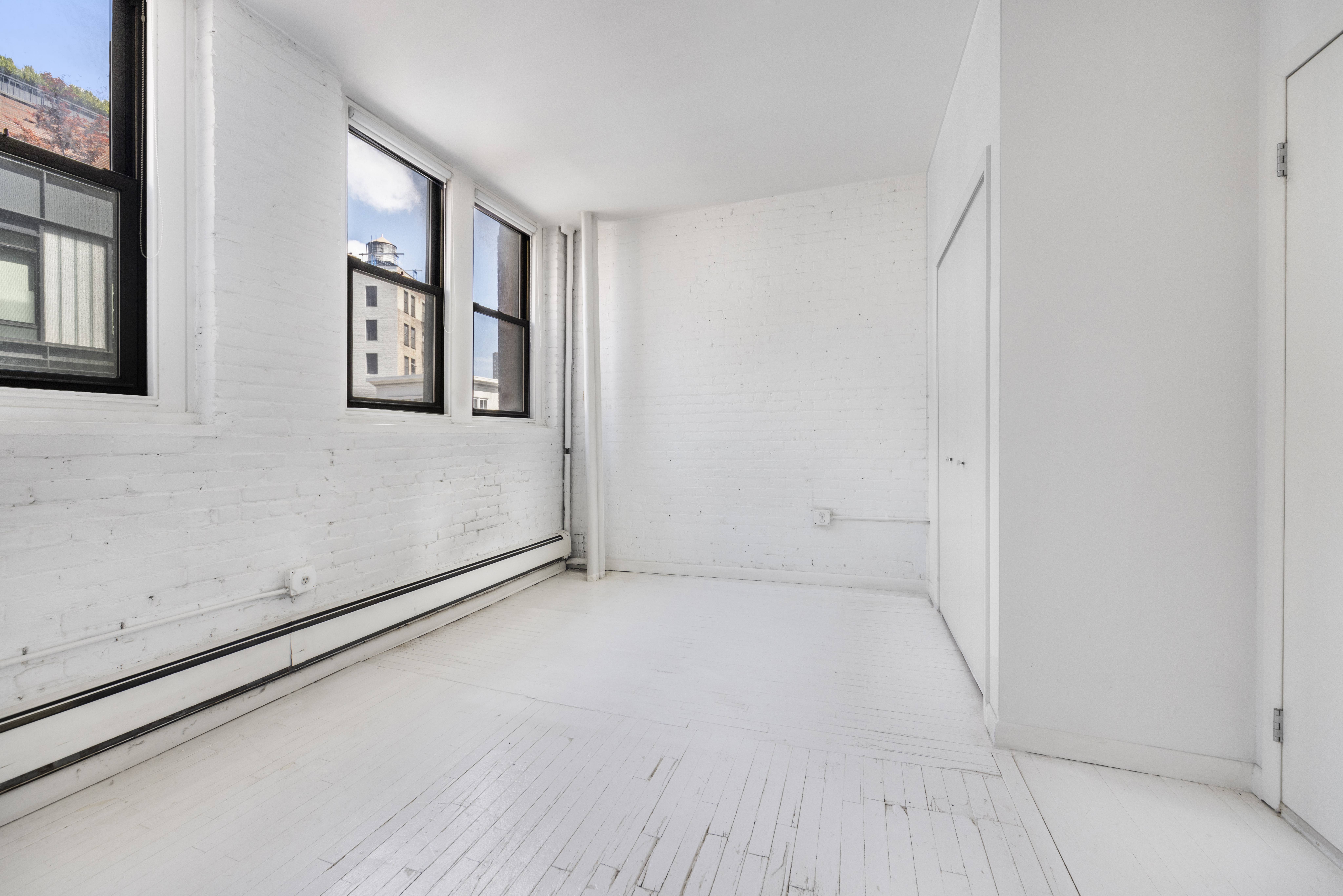 10 Leonard Street, Unit 6N Manhattan, NY 10013 - Photo 7 of 12 a view of an empty room with a window