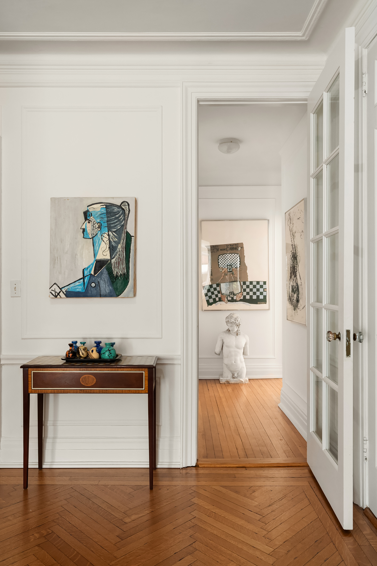 885 West End Avenue, Unit 8A Manhattan, NY 10025 - Photo 4 of 12 a view of a hallway with wooden floor and cabinet
