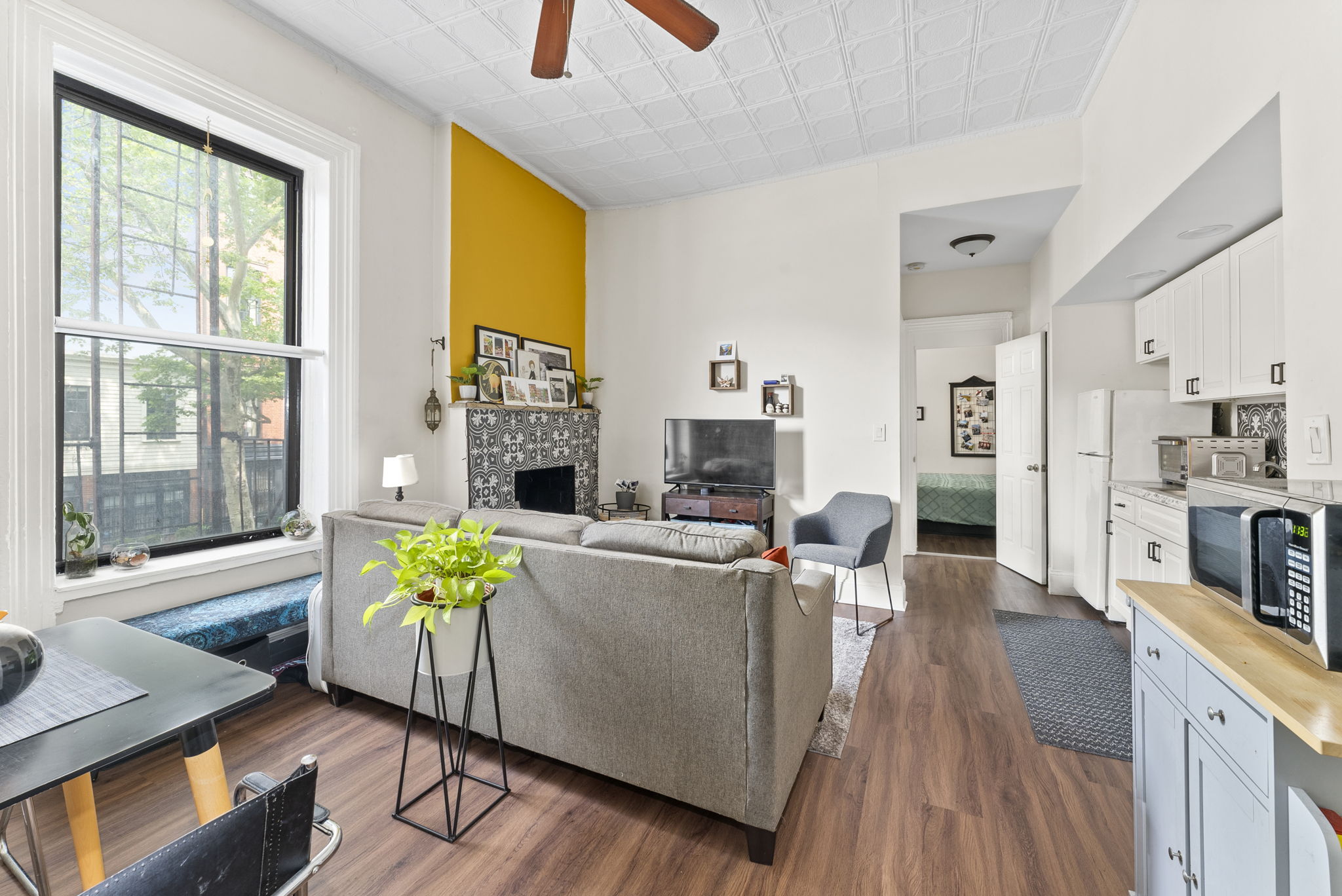 311 Henry Street, Unit 1 Brooklyn, NY 11201 - Photo 2 of 7 a living room with fireplace furniture and a large window