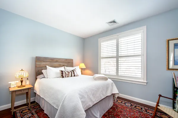 a bedroom with furniture and a chandelier