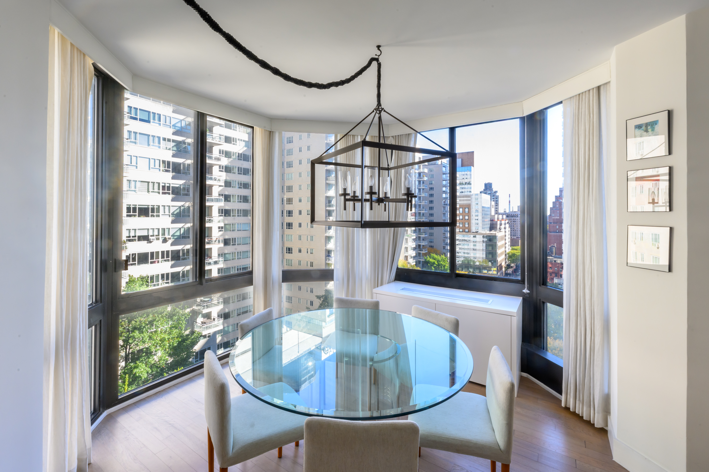 200-210 East 65th Street, Unit 11D Manhattan, NY 10065 - Photo 2 of 15 a dining room with furniture a chandelier and wooden floor