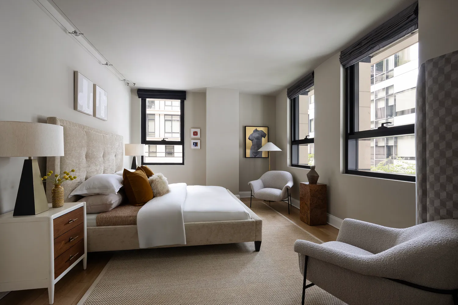 a bedroom with bed couch and window