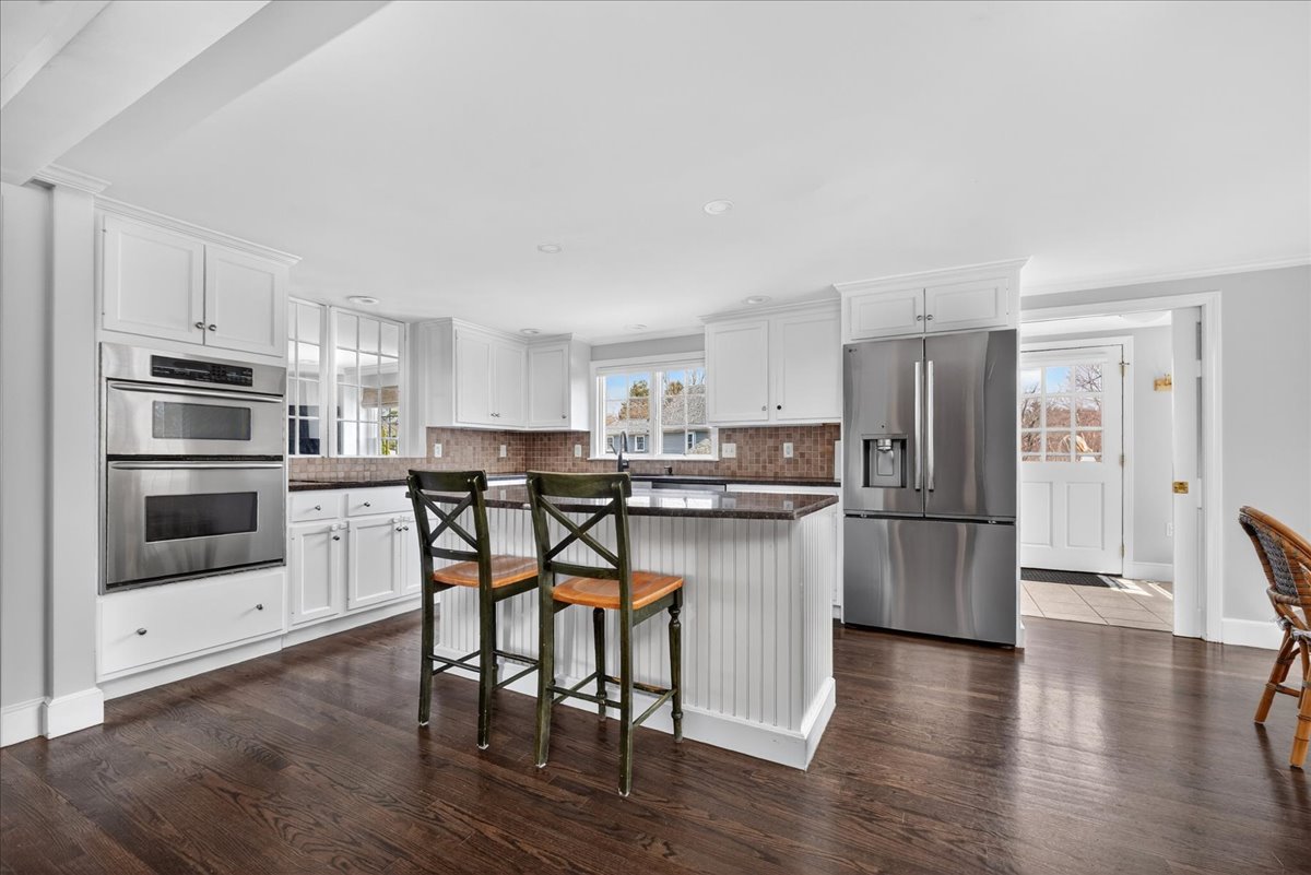 6 Studley Road Hingham, MA 02043 - Photo 9 of 27 a kitchen with stainless steel appliances a refrigerator a stove top oven and white cabinets