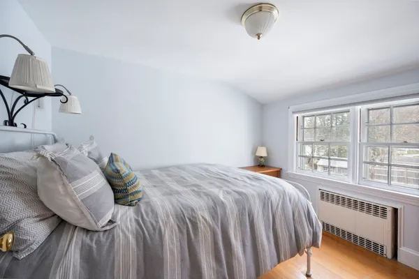 a bed sitting in a bedroom next to a window