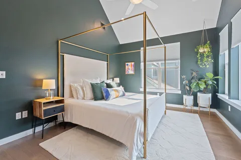 a room with a bed and a potted plant