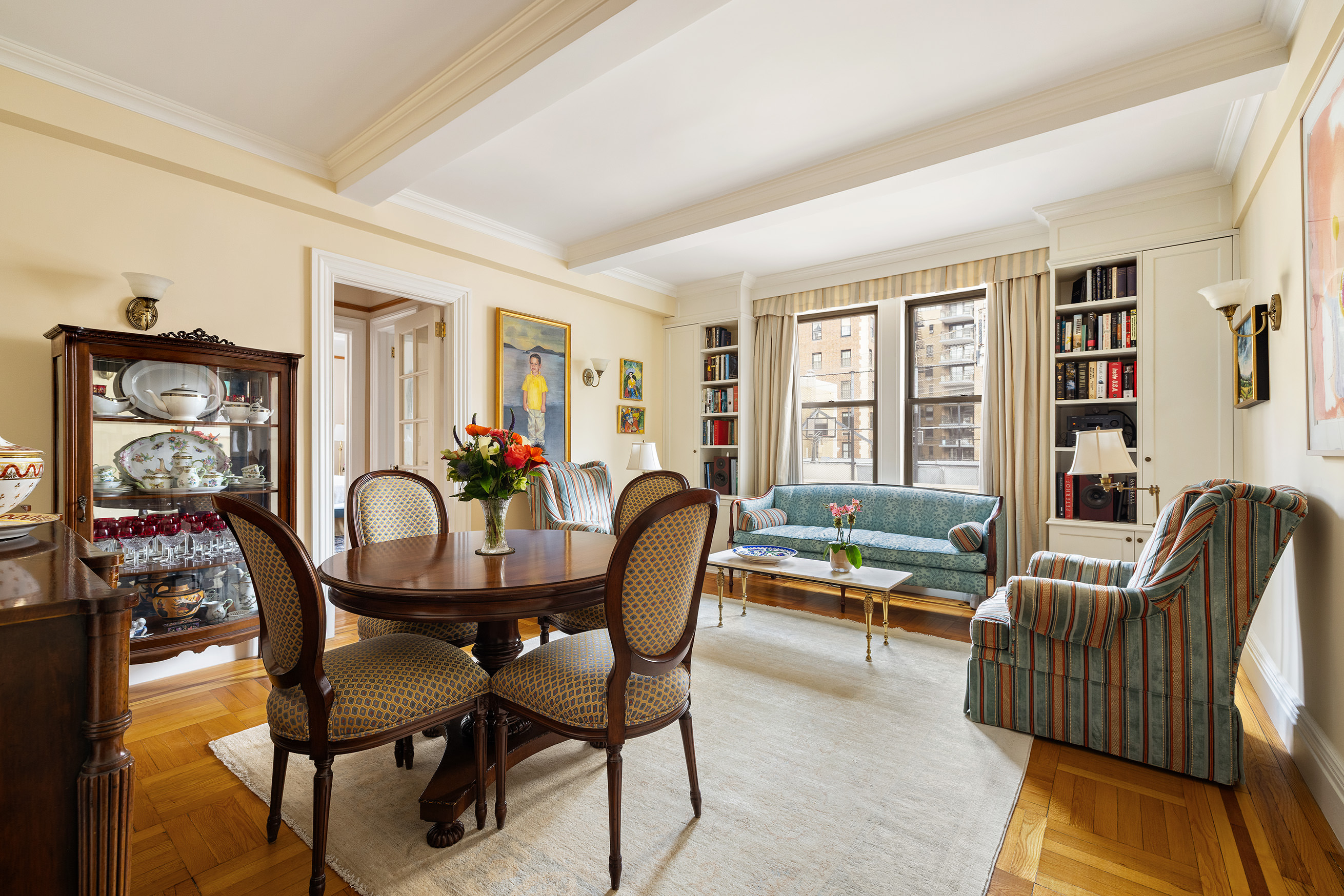 119 East 84th Street, Unit 9C Manhattan, NY 10028 - Photo 1 of 10 a dining room with furniture a livingroom view and wooden floor