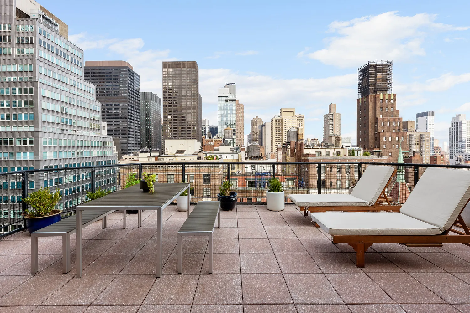 a terrace with outdoor seating and city view