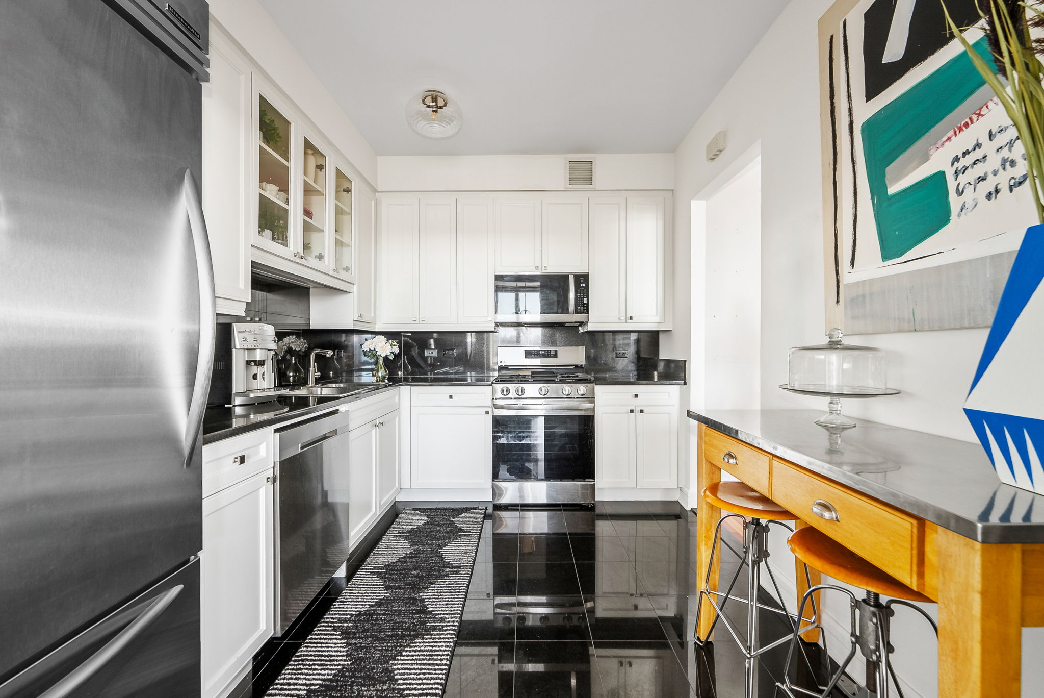 220 Riverside Boulevard, Unit 4M Manhattan, NY 10069 - Photo 3 of 11 a kitchen with stainless steel appliances granite countertop a stove and a sink