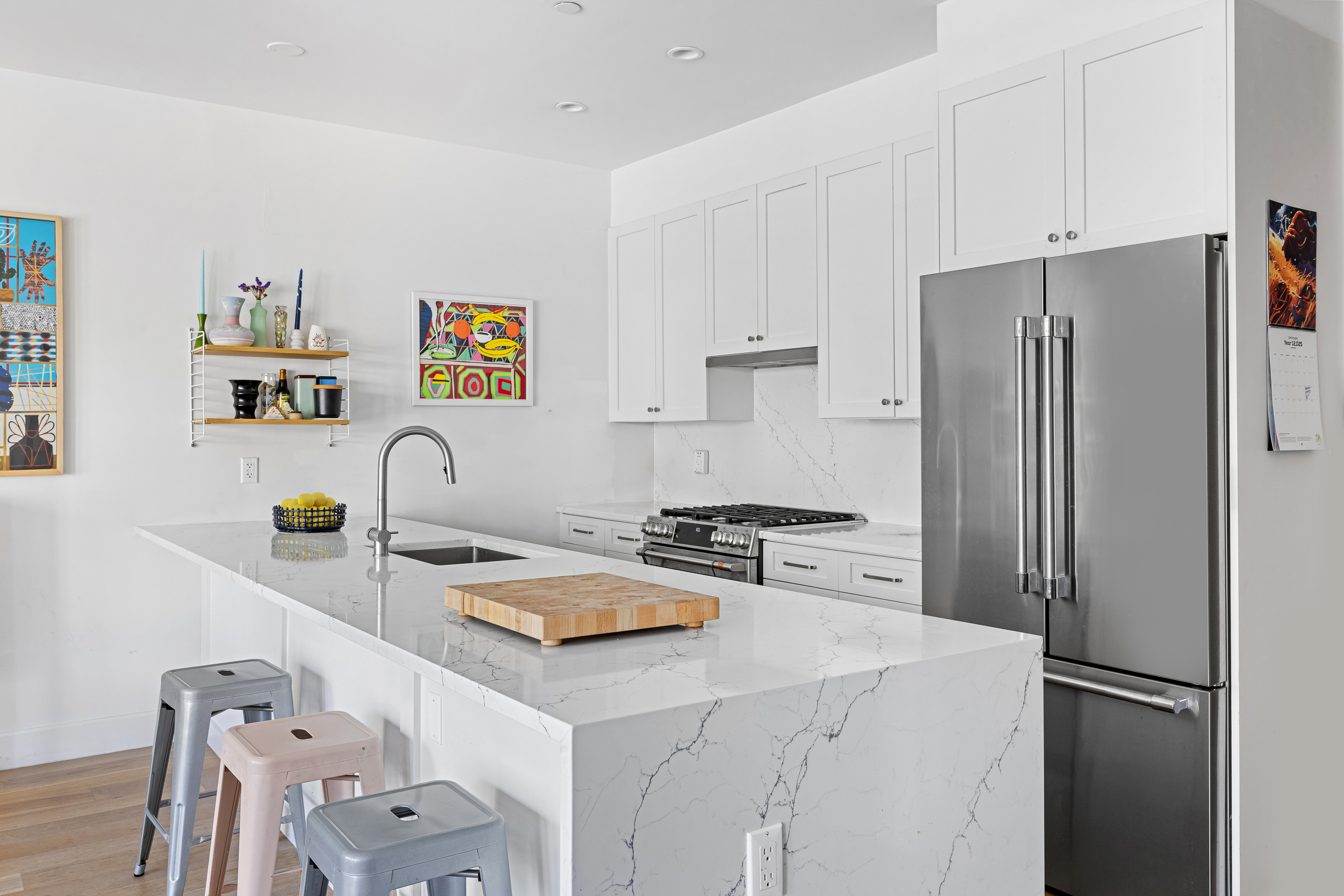 49 East 4th Street Brooklyn, NY 11218 - Photo 6 of 16 a kitchen with stainless steel appliances a refrigerator sink and white cabinets