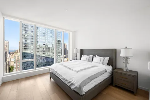 a bedroom with a large bed and a large window