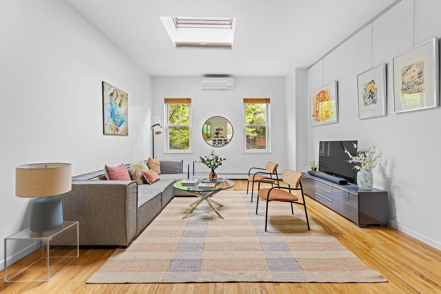 a living room with fireplace furniture and a rug