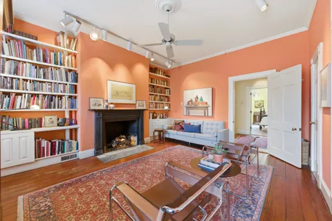 a living room with furniture and a chandelier