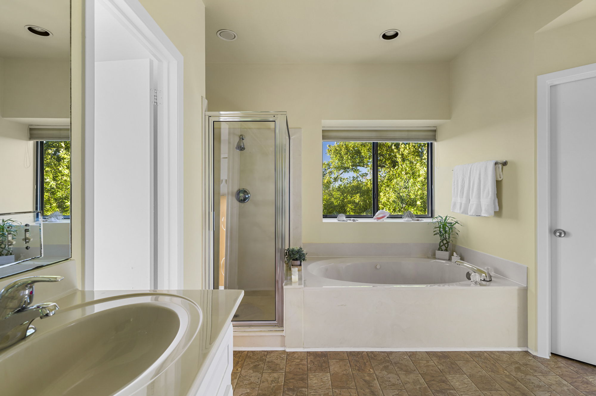 1605 The High Road Austin, TX 78746 - Photo 27 of 45 a white bath tub sitting in a bathroom next to a window