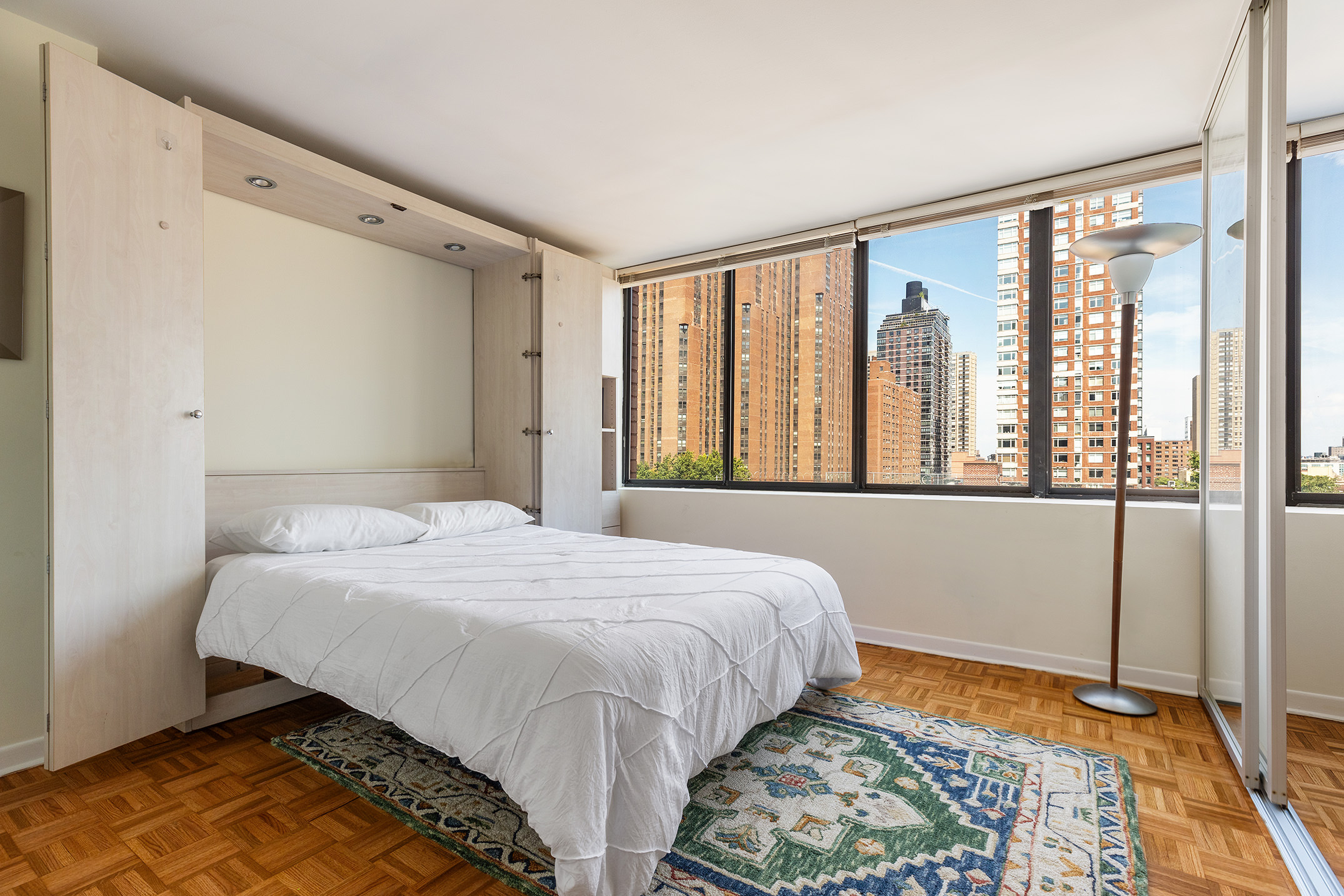 300 East 90th Street, Unit 7C Manhattan, NY 10128 - Photo 5 of 12 a bedroom with a bed and a window