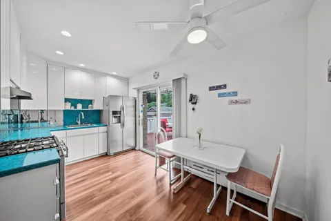 a kitchen with a table and chairs