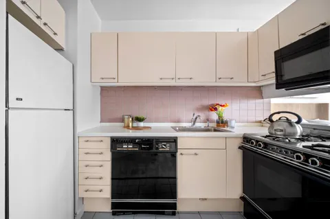 a kitchen with stainless steel appliances granite countertop a stove and a refrigerator