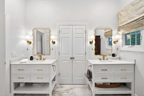 a bathroom with a double vanity sink mirror and double