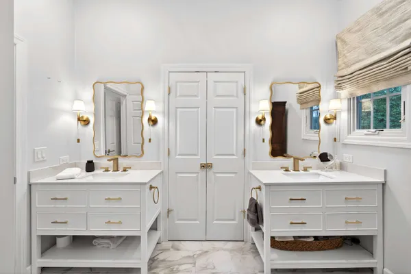 a bathroom with a double vanity sink mirror and double