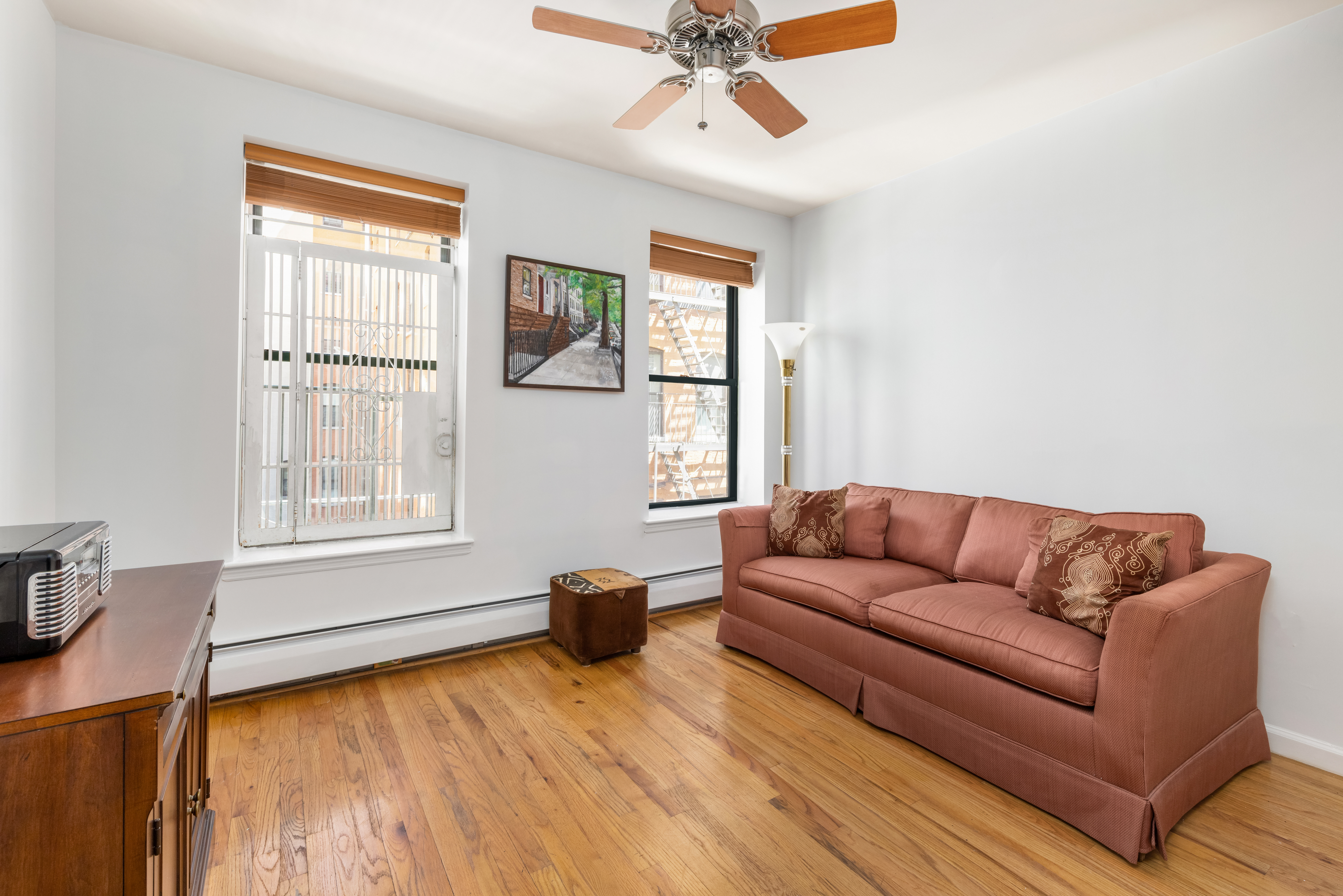 231 West 148th Street, Unit 2L Manhattan, NY 10039 - Photo 10 of 15 a living room with furniture and a window