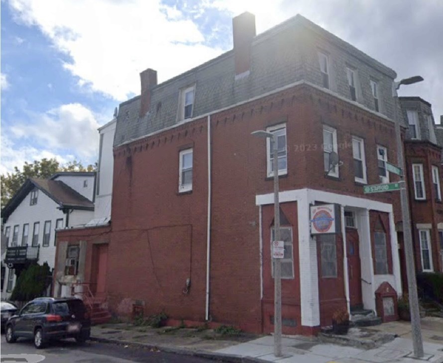 a red building in front of a brick building