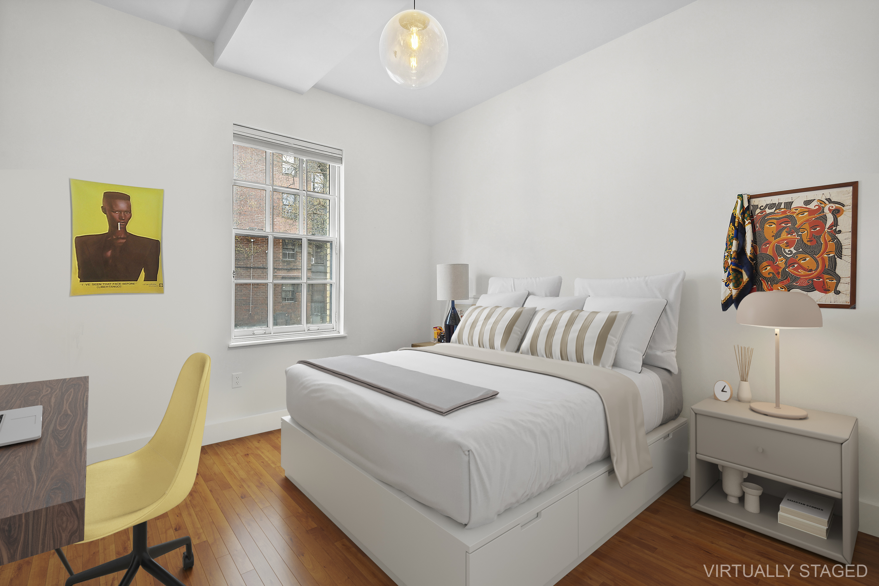 180 Bainbridge Street, Unit 112 Brooklyn, NY 11233 - Photo 4 of 30 a bedroom with a bed and a table in it