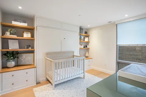 a spacious bedroom with a bed and a cabinets
