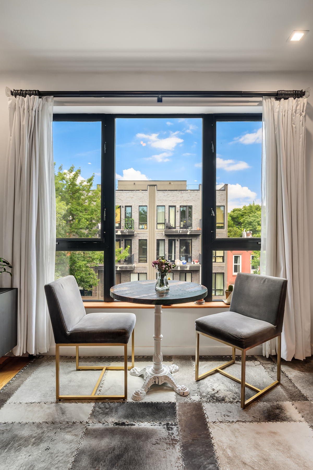 26 Eldert Street, Unit 4 Brooklyn, NY 11207 - Photo 2 of 10 a living room with furniture and a large window