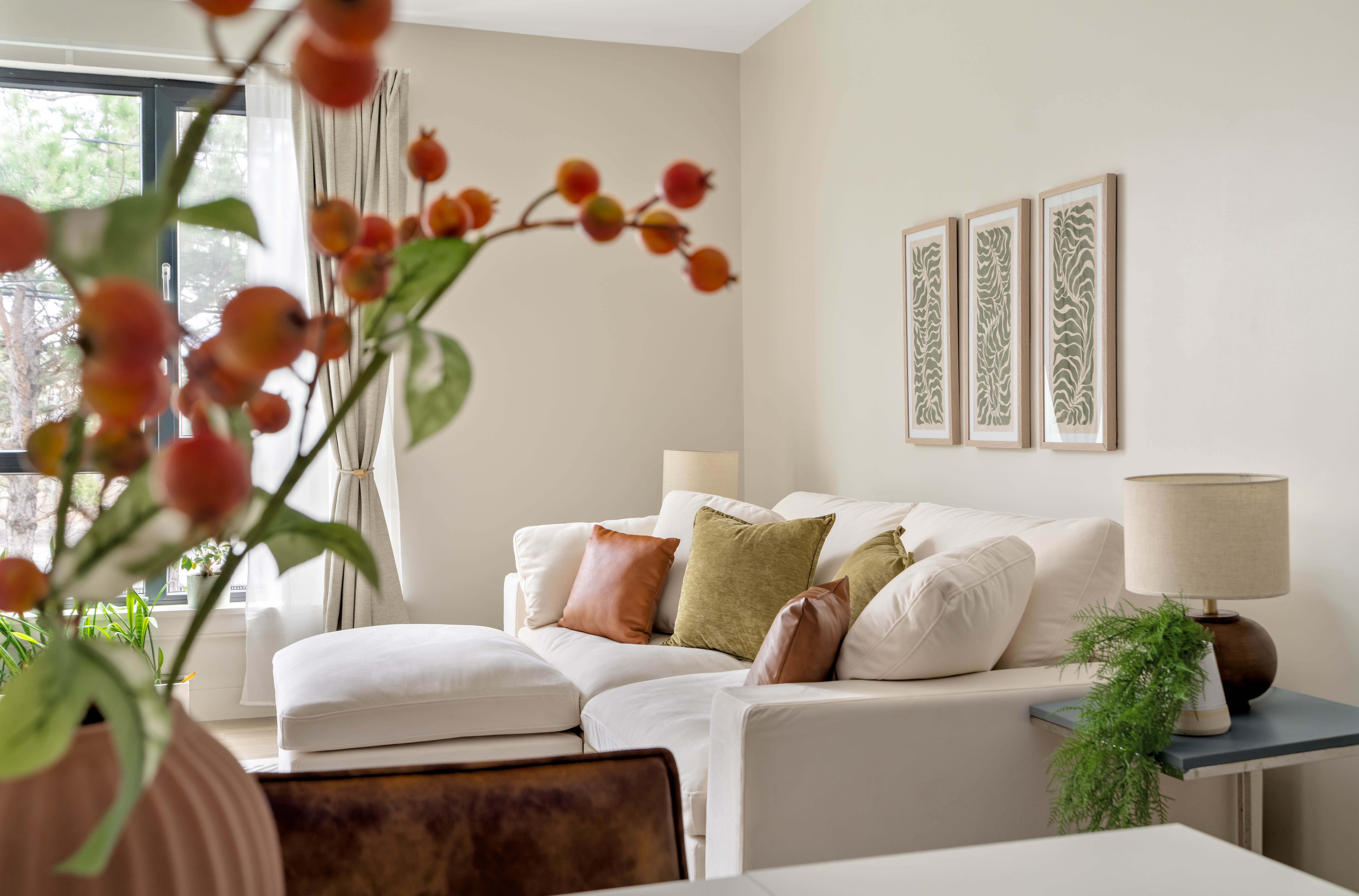 a living room with furniture and a potted plant