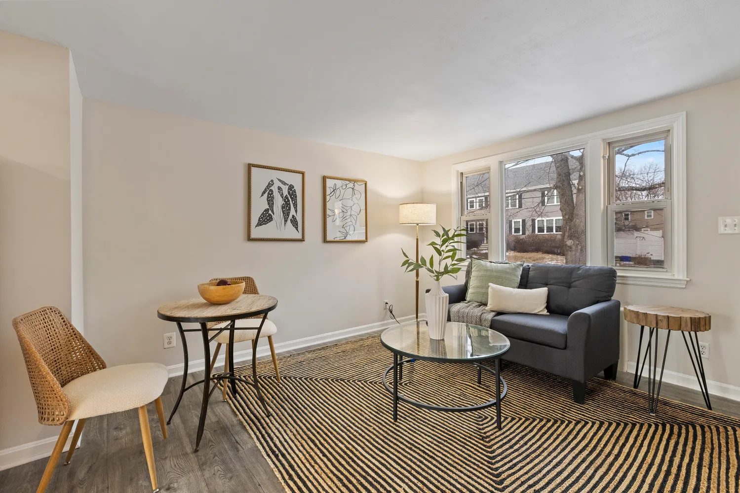 a living room with furniture a rug and a window