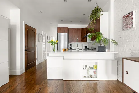 a kitchen with stainless steel appliances granite countertop a refrigerator and a stove
