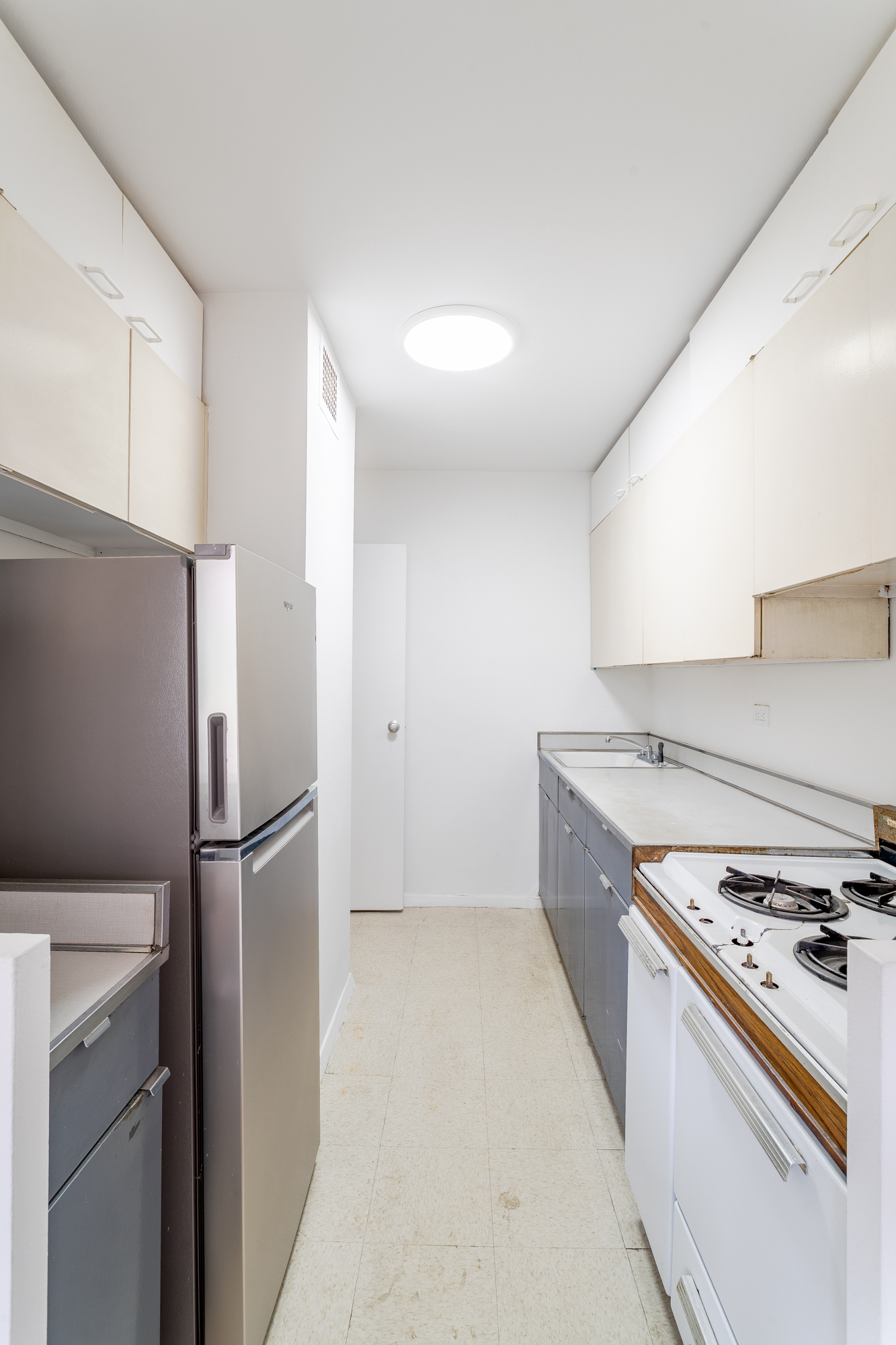 180 West End Avenue, Unit 5H Manhattan, NY 10023 - Photo 7 of 18 a kitchen with stainless steel appliances granite countertop a refrigerator and a stove
