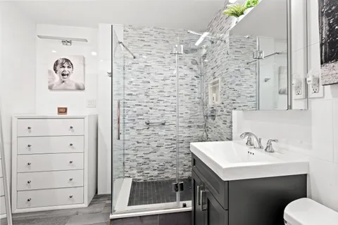 a bathroom with a shower and a sink
