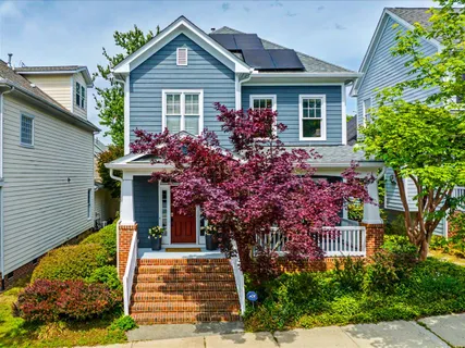 a front view of a house with outdoor seating