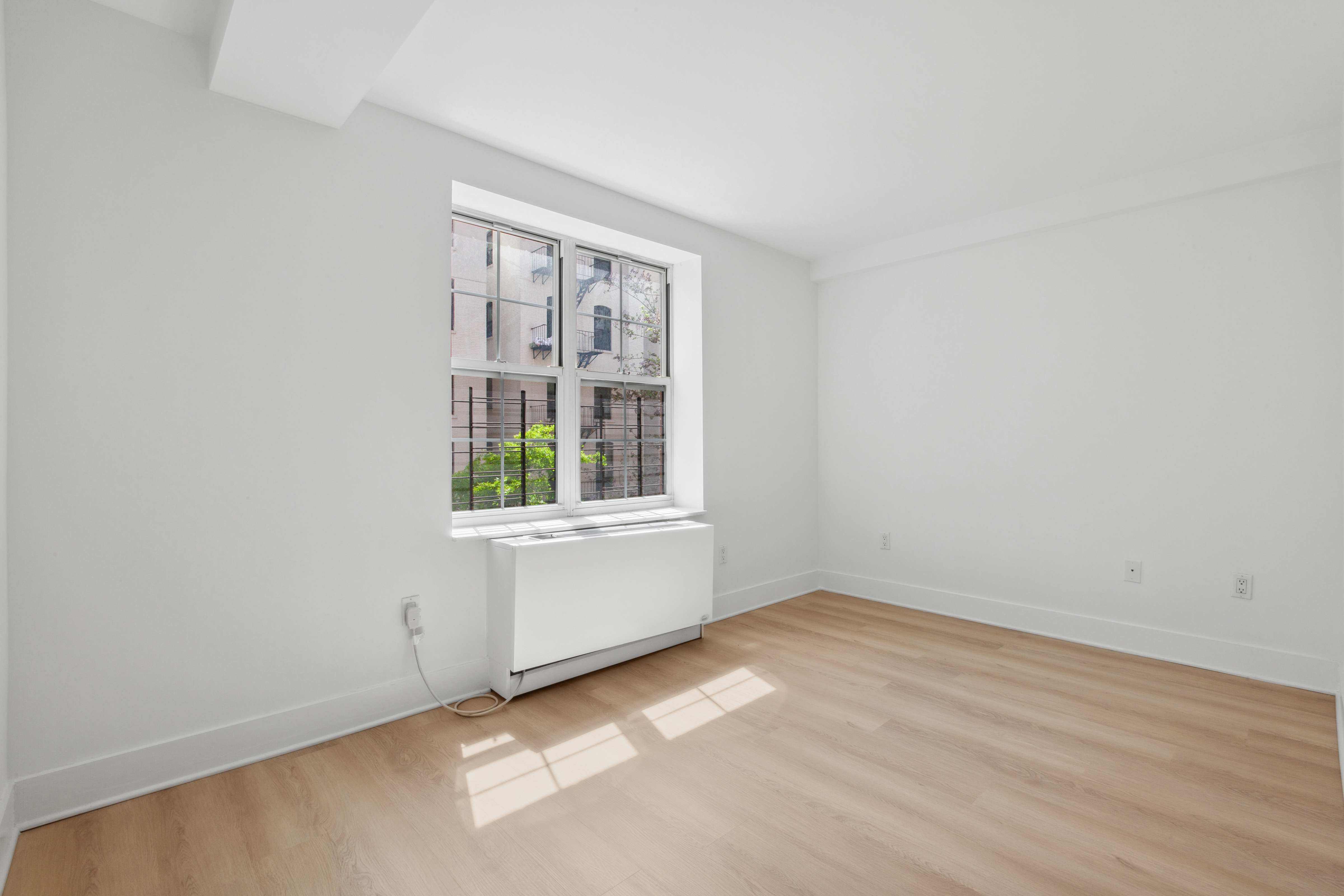 266 West 115th Street, Unit 2B Manhattan, NY 10026 - Photo 5 of 11 an empty room with window