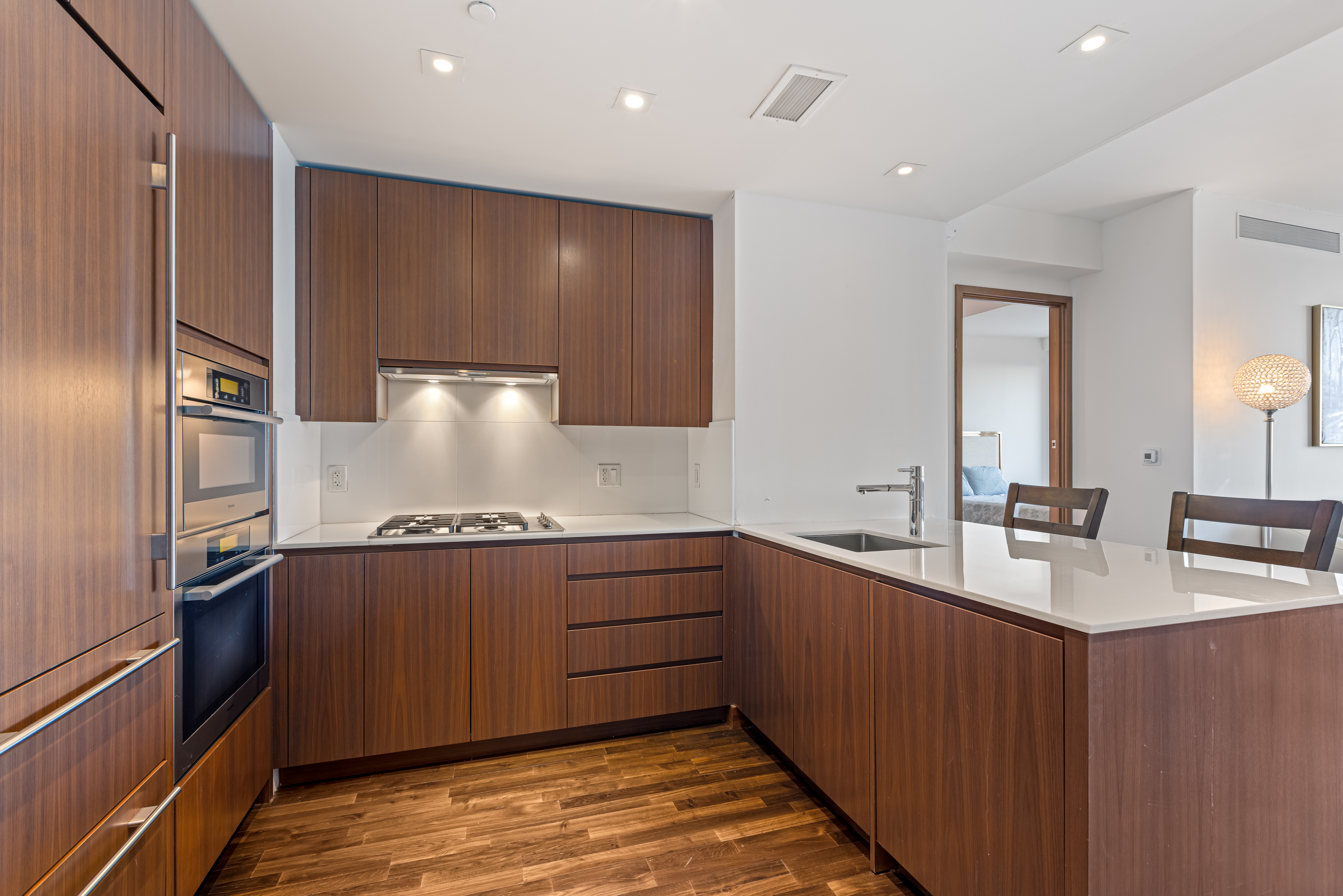 400 5th Avenue, Unit 49C Manhattan, NY 10018 - Photo 4 of 21 a kitchen with stainless steel appliances granite countertop a sink stove and refrigerator