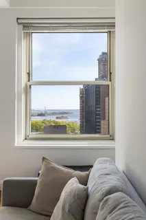 a living room with a large window and a couch