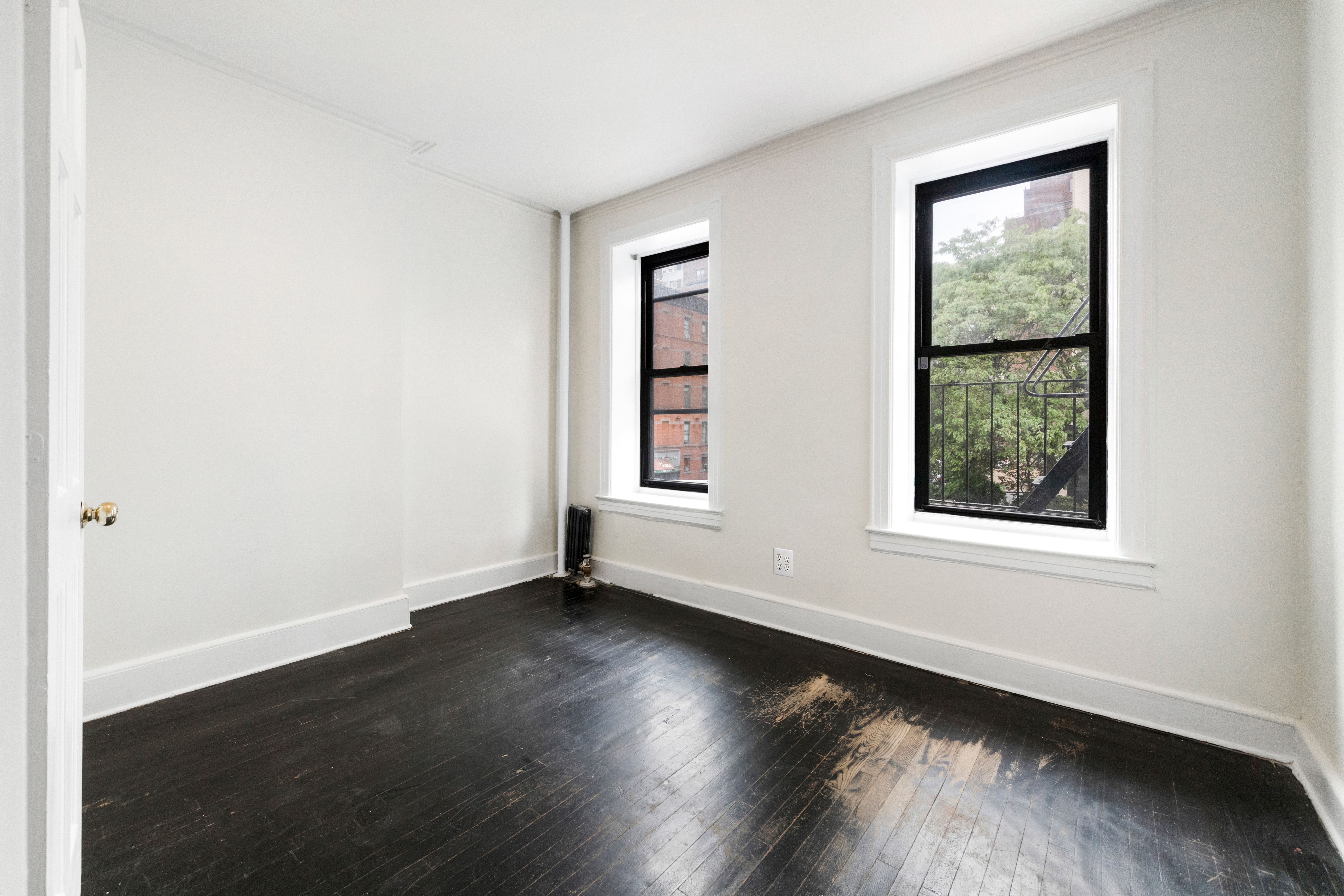 1605 York Avenue, Unit 2A Manhattan, NY 10028 - Photo 1 of 8 an empty room with wooden floor and windows