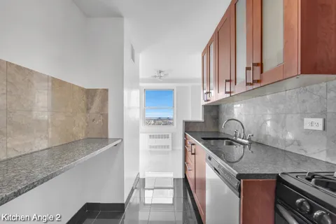 a kitchen with stainless steel appliances granite countertop a sink stove and cabinets
