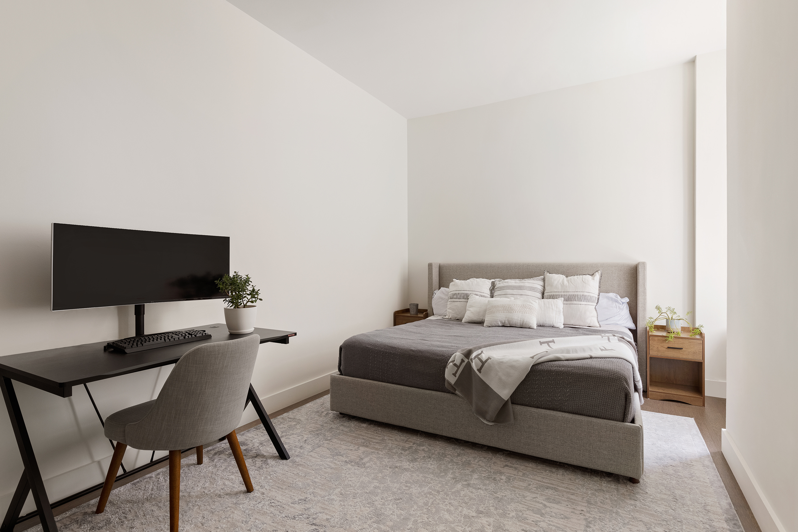 25 Broad Street, Unit 6T Manhattan, NY 10004 - Photo 6 of 13 a bedroom with a bed a chair and a potted plant