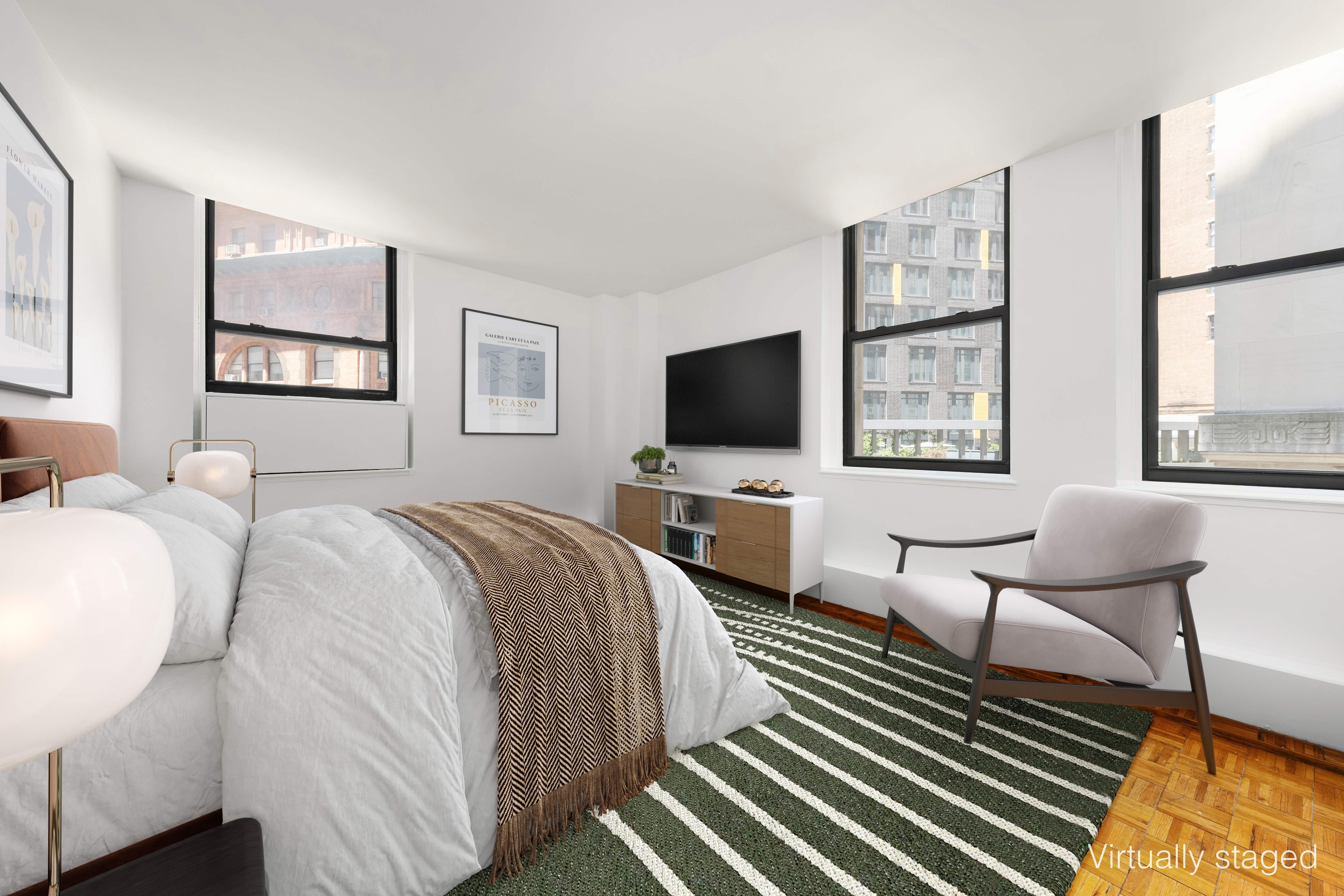 3 Hanover Square, Unit 4D Manhattan, NY 10004 - Photo 5 of 16 a bedroom with a bed and a flat screen tv