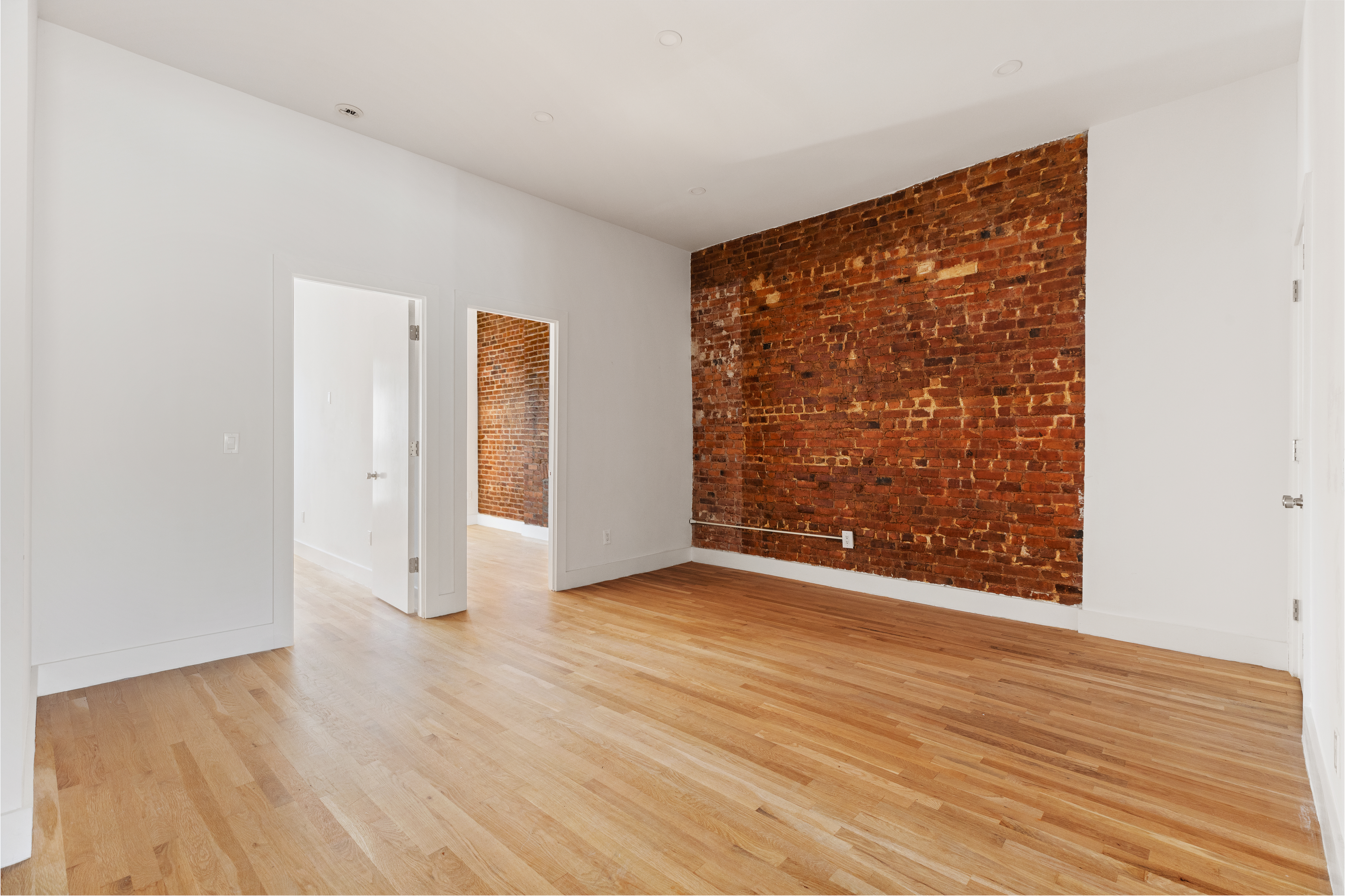 502 5th Avenue, Unit 3 Brooklyn, NY 11215 - Photo 3 of 10 a view of an empty room with wooden floor and a window