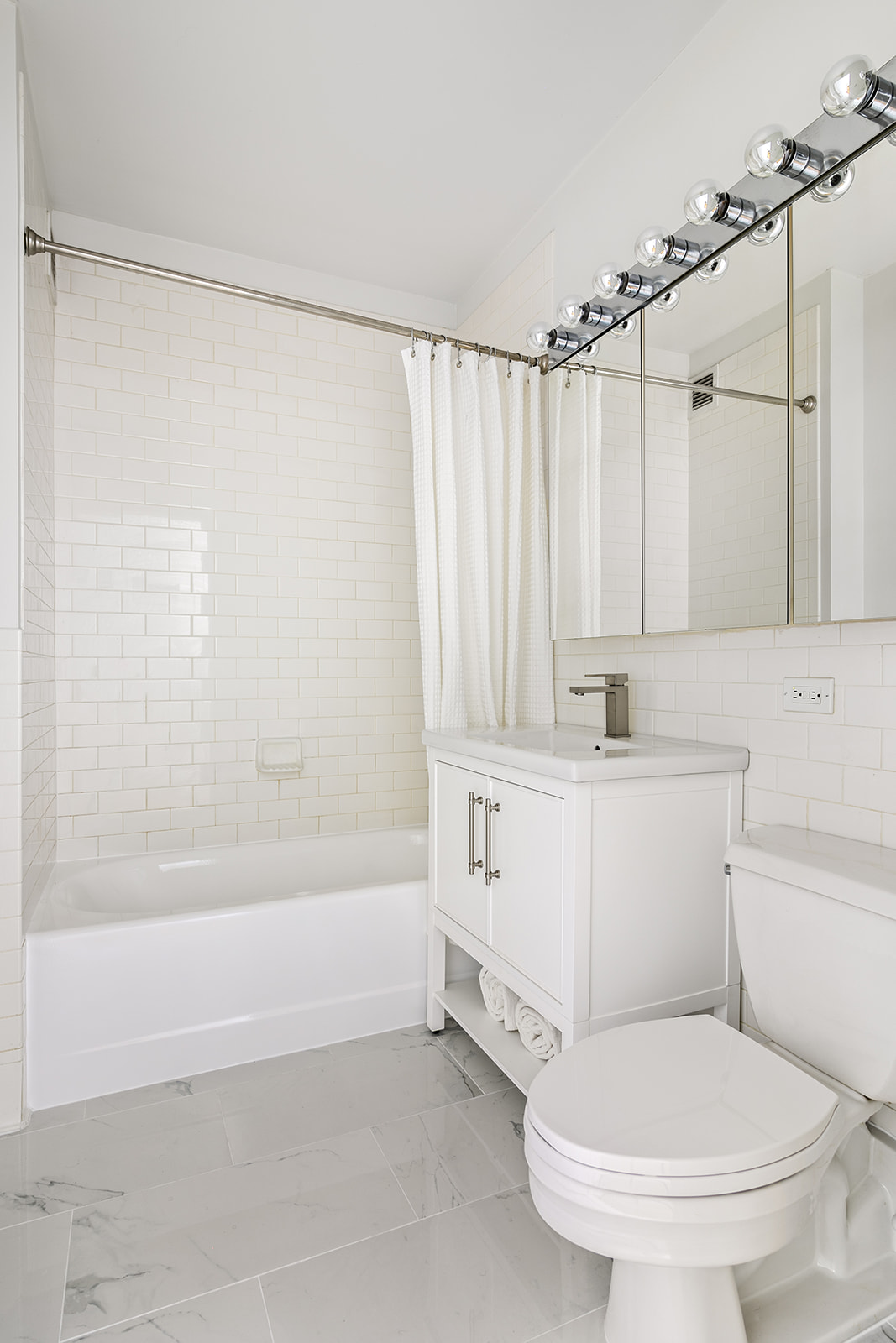 99 John Street, Unit 522 Manhattan, NY 10038 - Photo 6 of 11 a bathroom with a sink toilet and shower