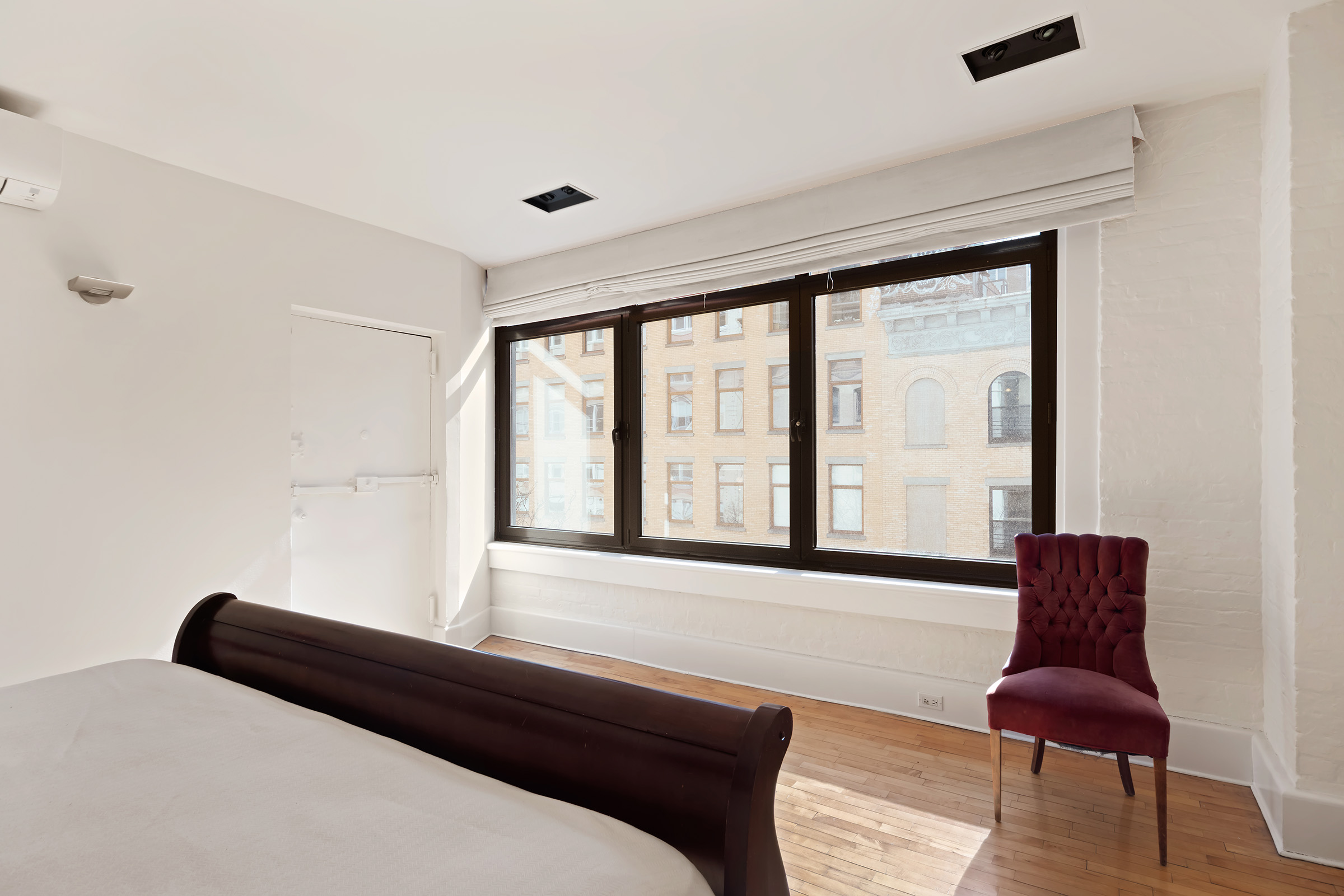 131 West 24th Street, Unit 5/6 Manhattan, NY 10011 - Photo 12 of 14 a bedroom with a bed and a chair